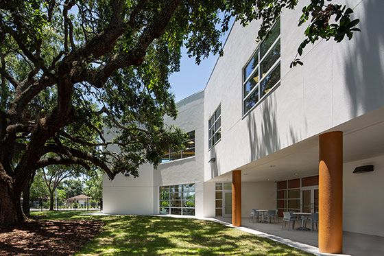 Exterior side view with large oak tree